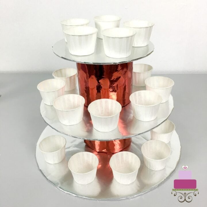 A 3 tier cupcake holder in silver and red