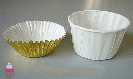 Empty gold cupcake casing and white muffin casing