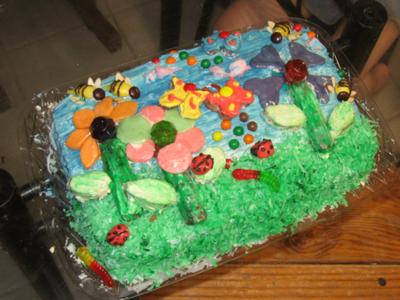 A rectangle cake decorated with candies to form flowers.