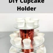 A 3 tier red and silver cupcake holder with empty muffin cups.