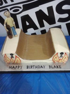 Half pipe shaped cake with a human figurine topper