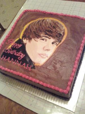 Square cake with brown icing and Justin Bieber image
