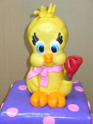 A square tiered cake with Tweety Bird topper