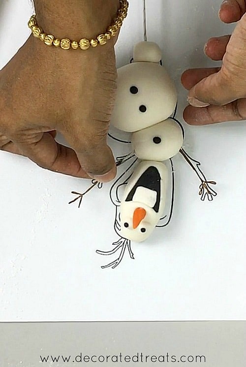 Attaching Olaf's arms.