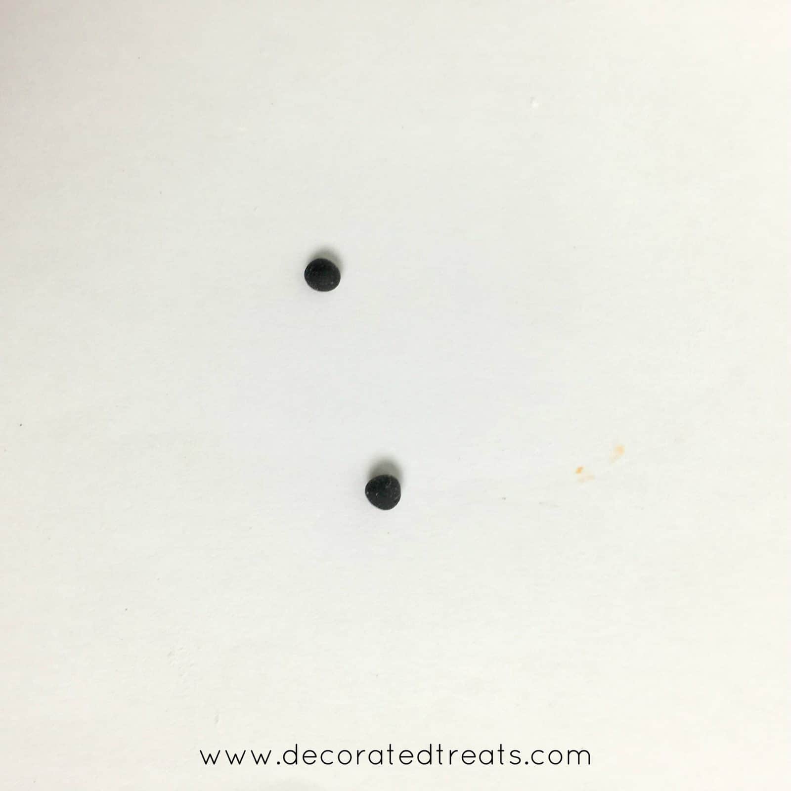 2 tiny round balls in black fondant