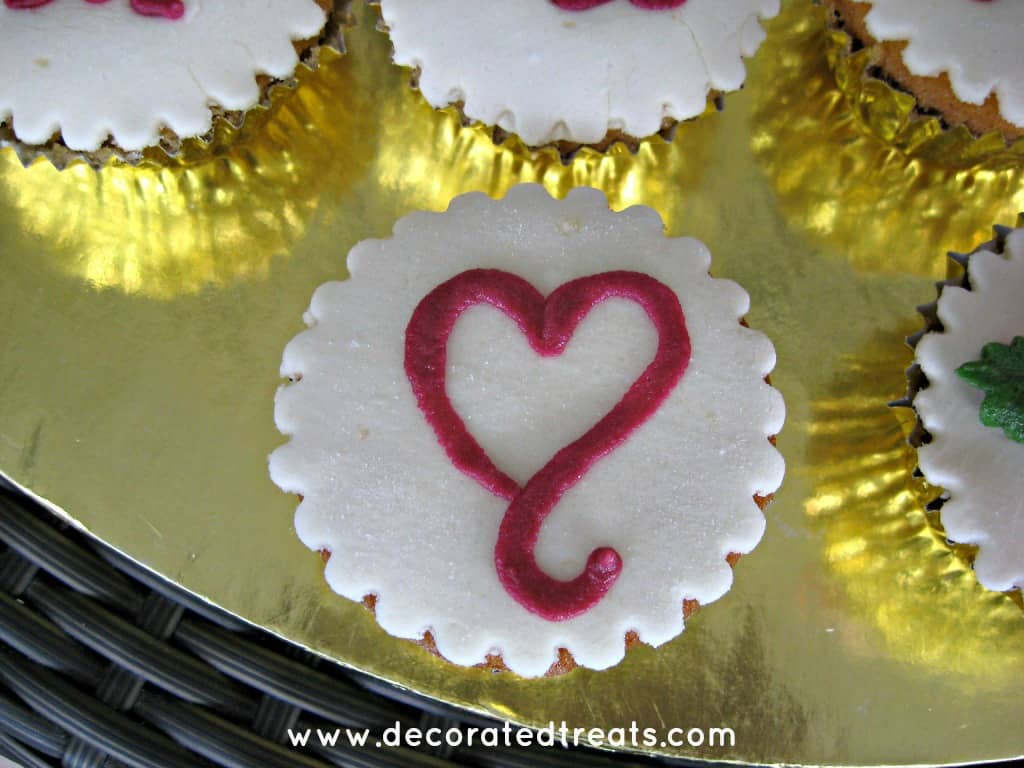 A white cupcake with pink heart