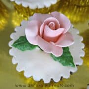 A cupcake with pink fondant rose.