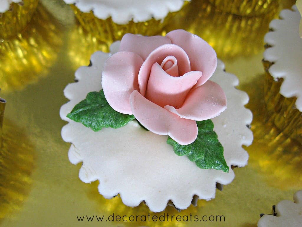 A cupcake with pink fondant rose for a happy birthday cupcake set