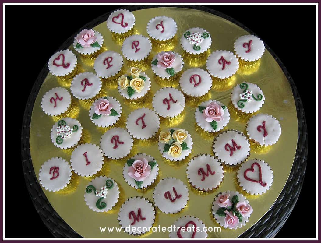 A set of happy birthday cupcakes with a combination of letters and floral design