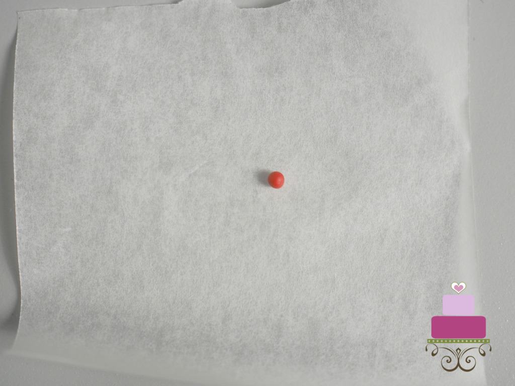 A tiny ball of red fondant