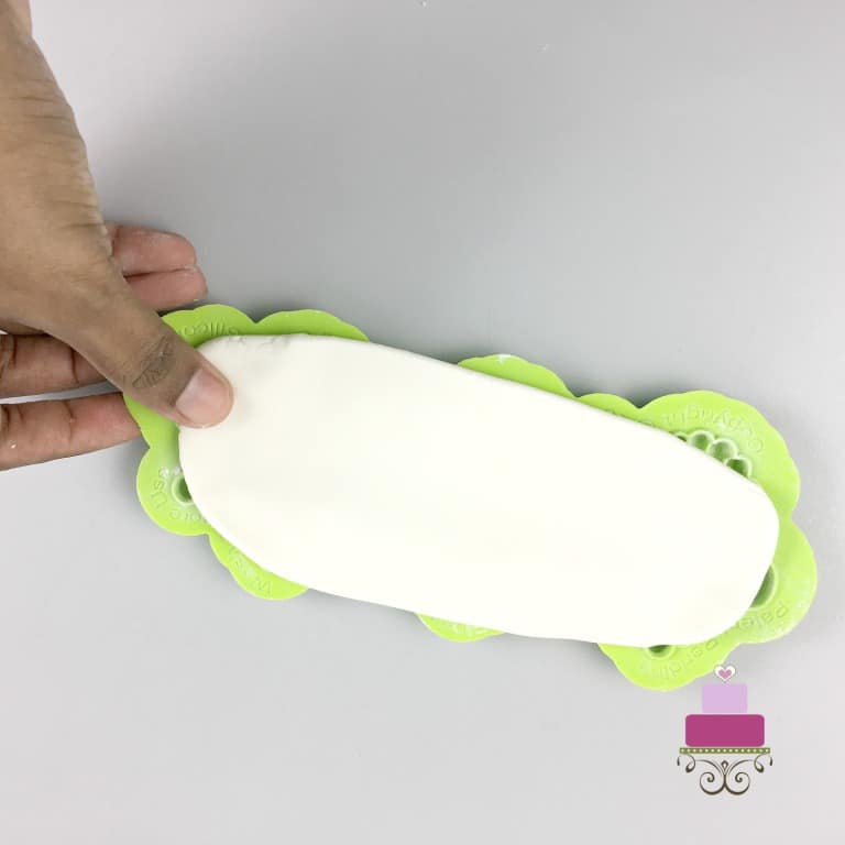 Placing rolled fondant on a silicone fondant mold
