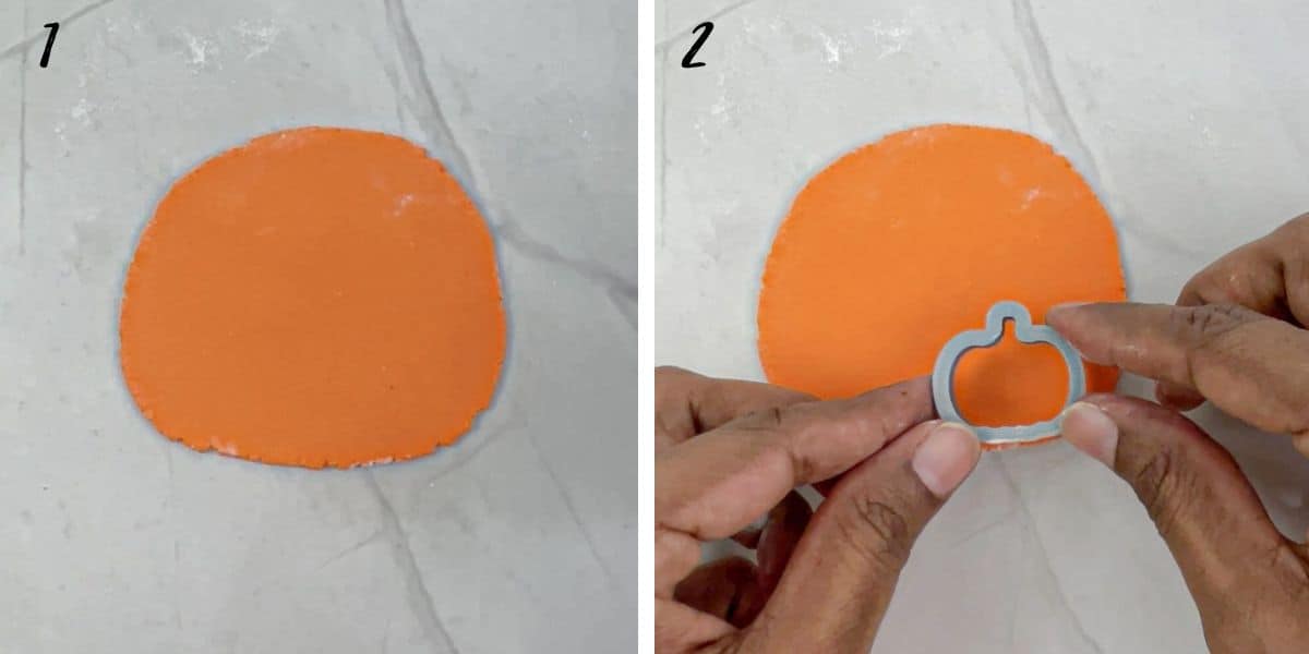 A piece of rolled orange fondant and holding a pumpkin cutter in hands.