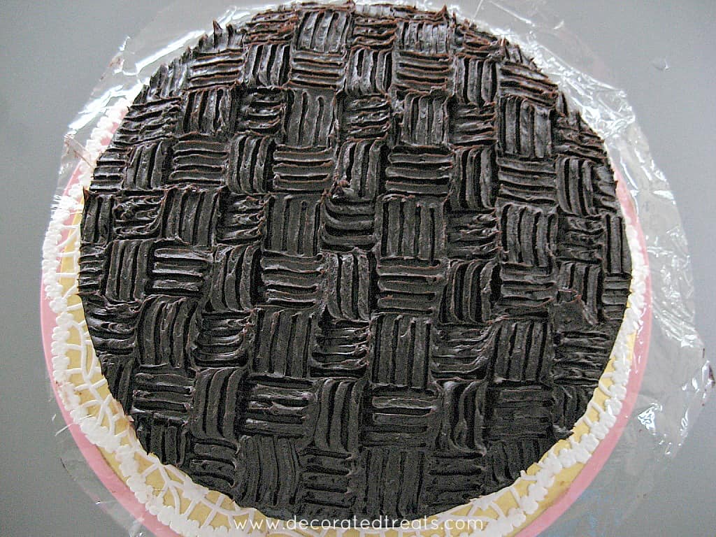 A chocolate cake with basket weave patterned icing