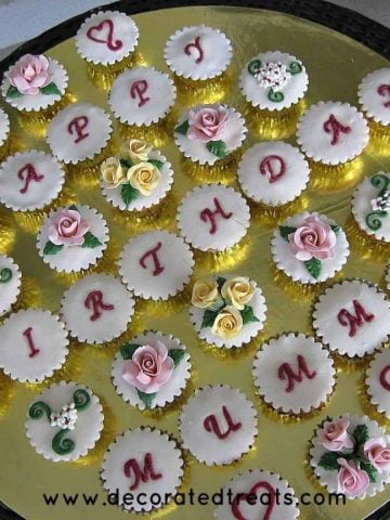 A set of happy birthday cupcakes with a combination of letters and floral design for mom birthday.