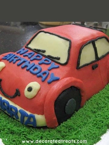 A 3d shaped car cake in red icing