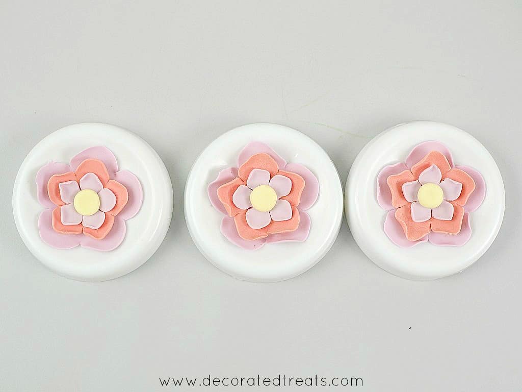 Pink and purple fondant flowers in 3 flower formers.
