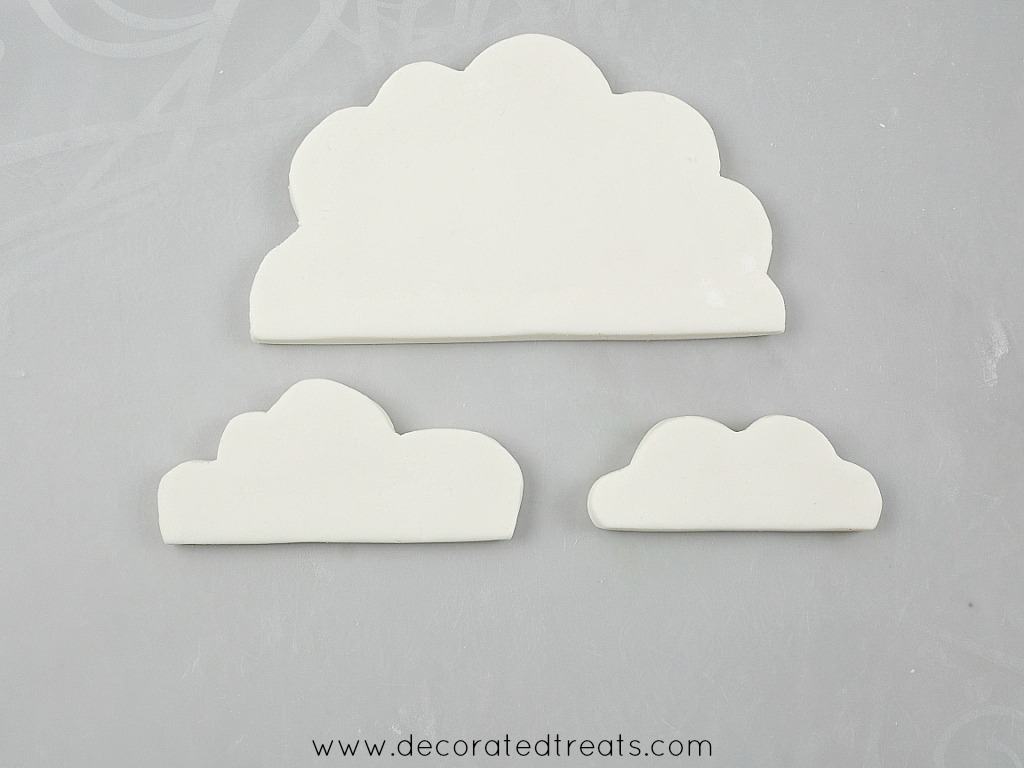 3 pieces of fondant cut in the shape of clouds