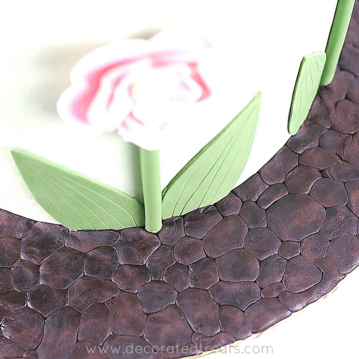 Brown fondant pebbles effect on cake board