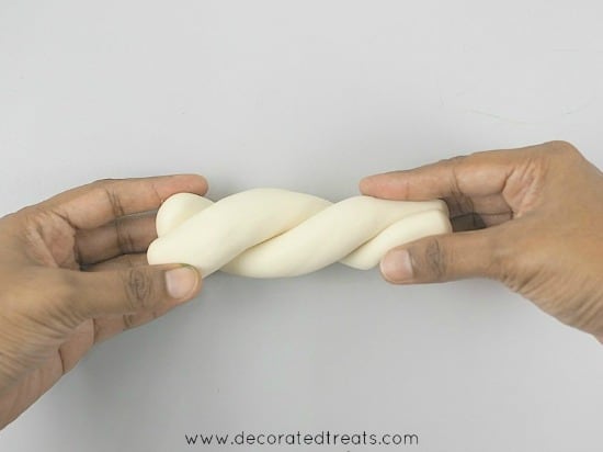 Twisting 2 rolls of fondant by hand
