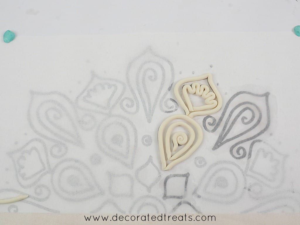Fondant strips arranged on lace paper template