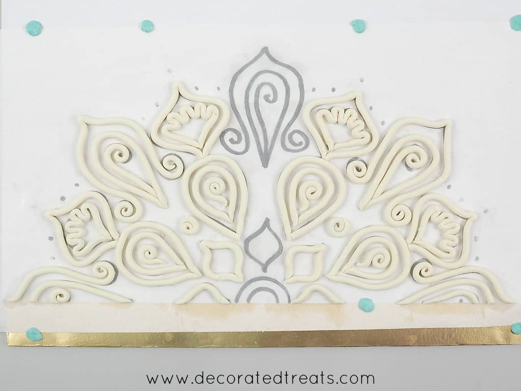 Fondant strips arranged on lace paper template