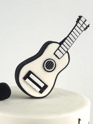 Black and white guitar cake topper.