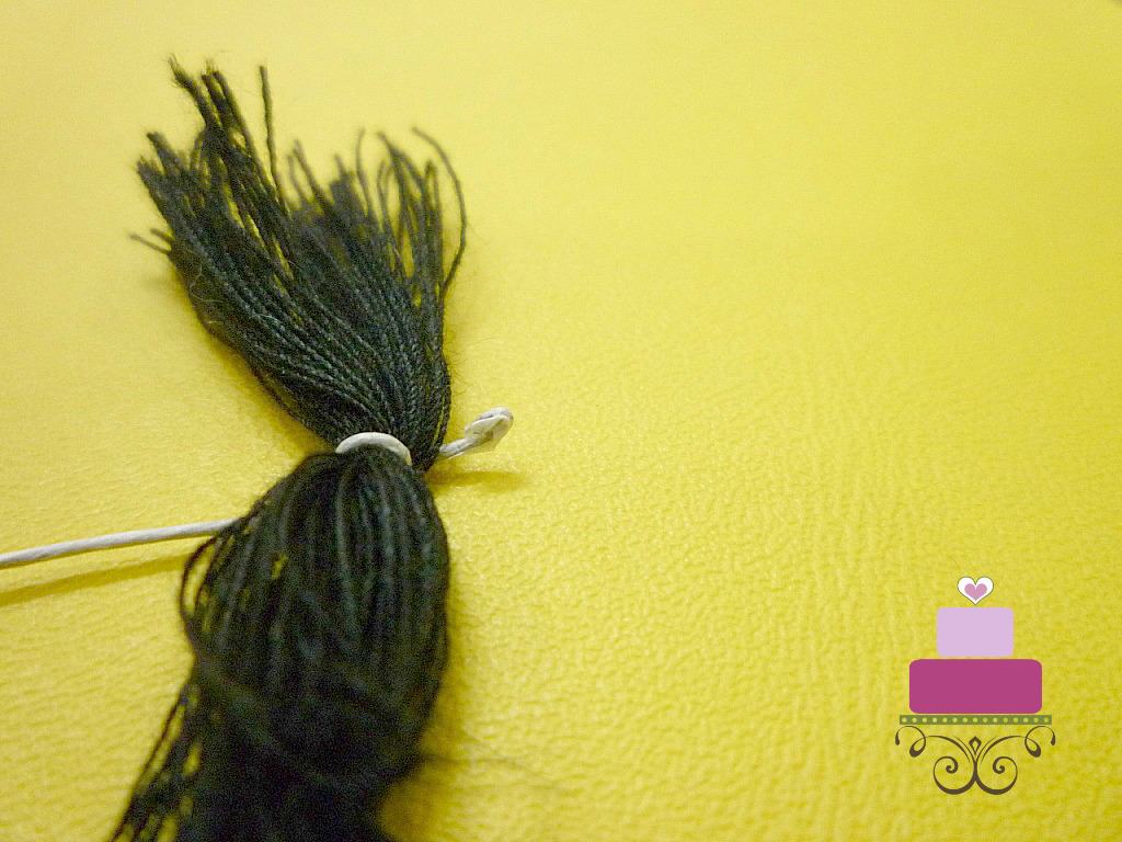 Short strands of black thread tied in the center with wire.