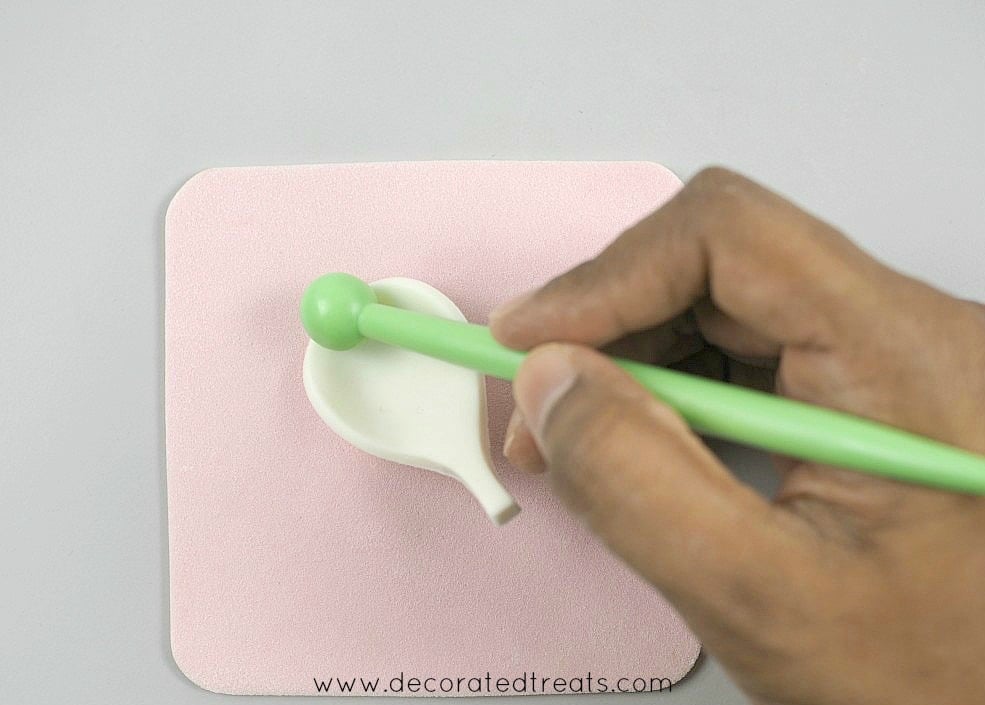 Using a ball tool to shape a gum paste petal