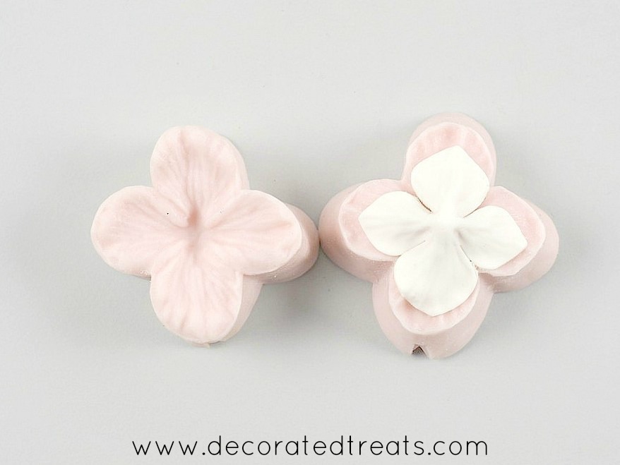 Silicone hydrangea formers with a gum paste hydrangea flower on.