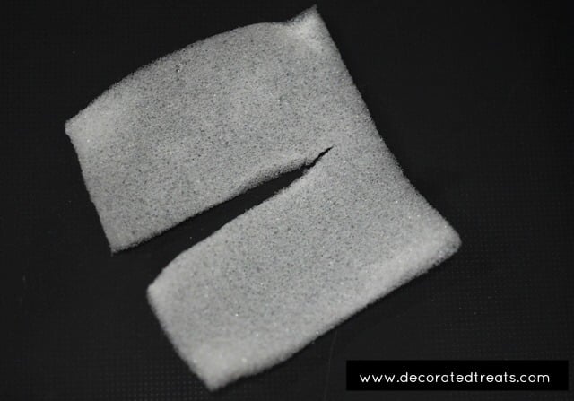 A square piece of sponge cut into half up to to almost 90%