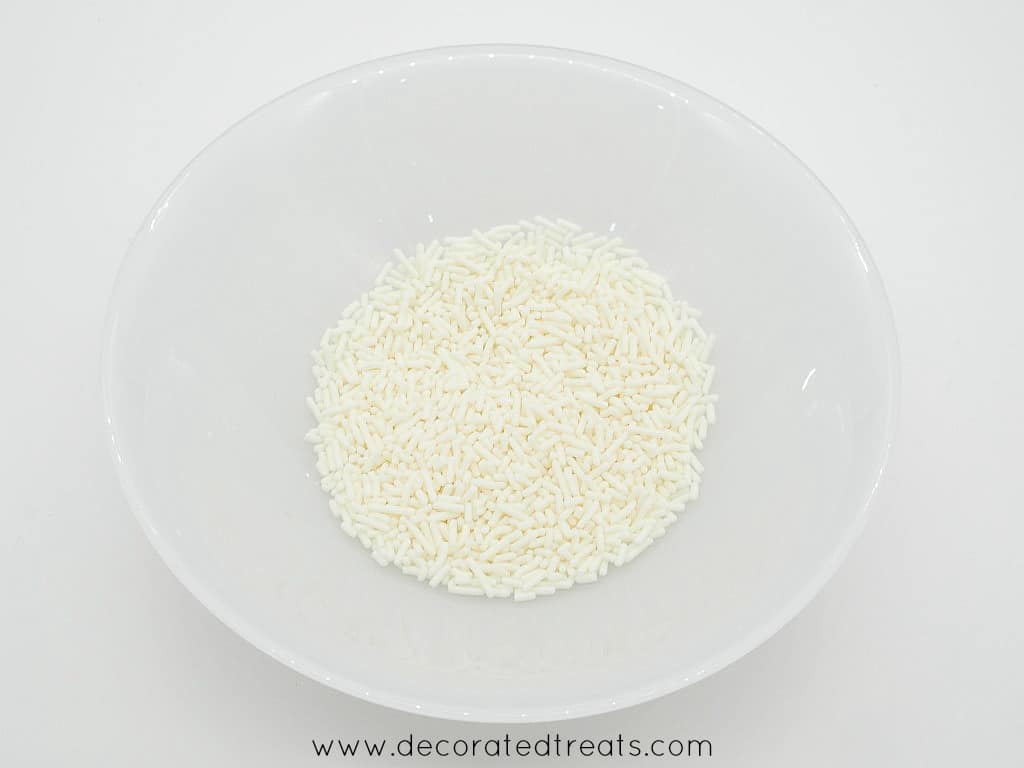 A white plate filled with white sprinkles