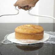 Layering a cake with a cake leveler.