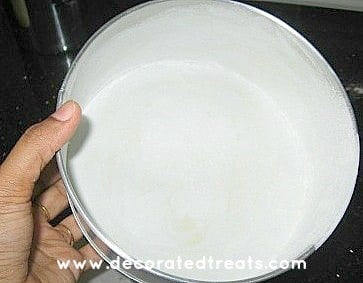 Round cake tin, greased and floured