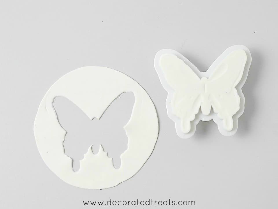 A round piece of gum paste with a butterfly shape cut out.