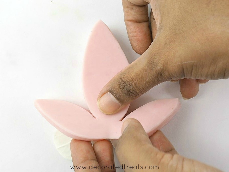Using a pink veining tool to imprint vein marks on gum paste flower petals