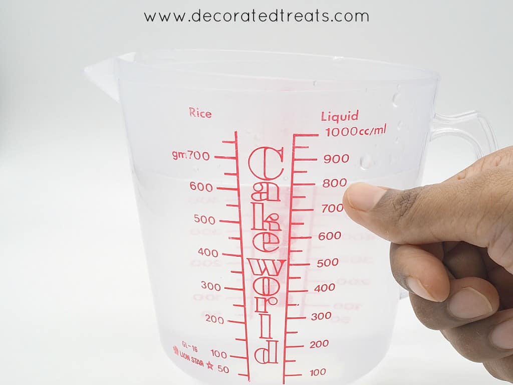 Pointing to a line on the measuring jug