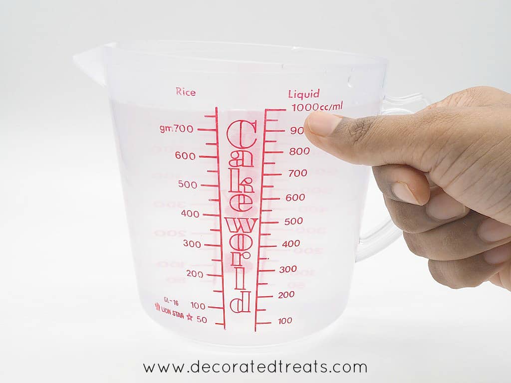 Pointing to a line on the measuring jug