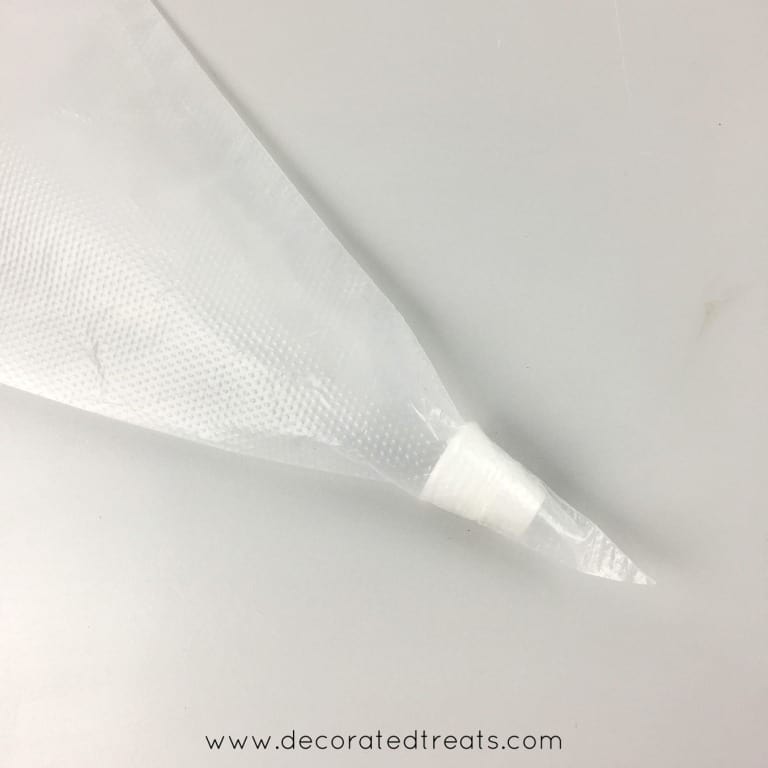 An icing coupler inside an empty piping bag