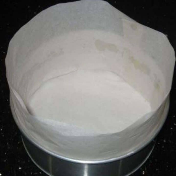 A round cake tin line with parchment paper