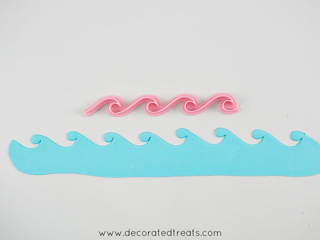 Fondant waves cut out. Above the cut out is a pink waves cutter