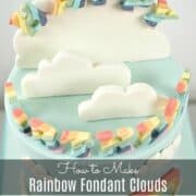 A poster with fondant clouds on a blue cake.