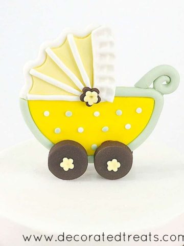 Stroller baby shower cake topper in yellow and green.