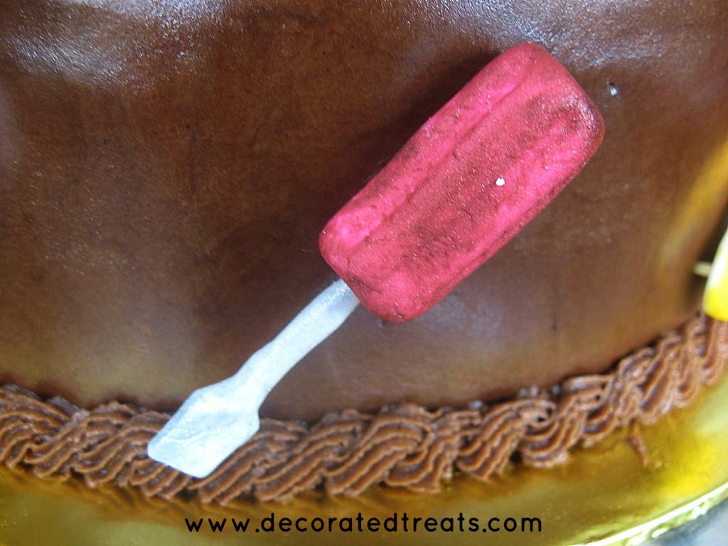 Fondant screwdriver on the side of a cake