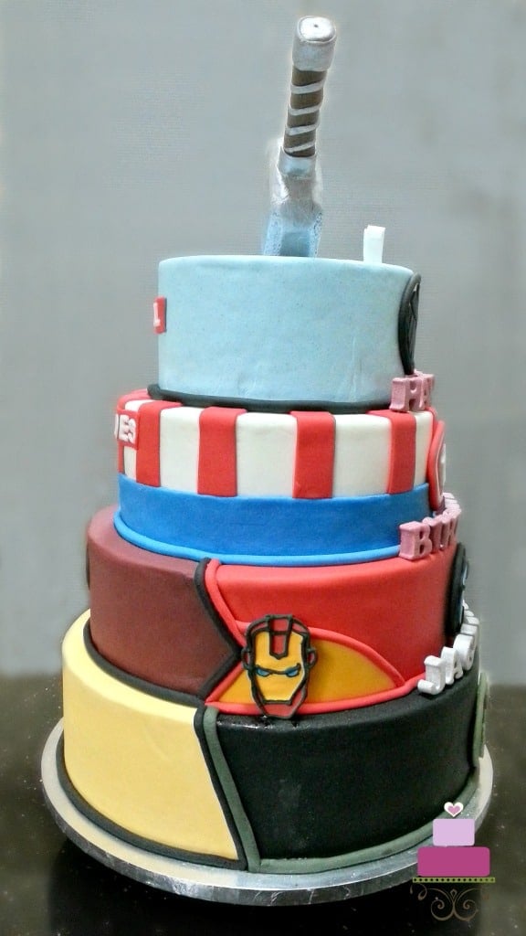 A 4-tier Marvel Superhero birthday cake with Thor hammer topper