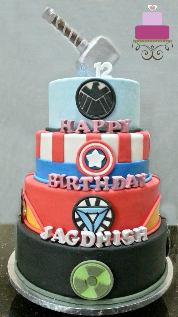 A 4-tier Marvel Superhero birthday cake with Thor hammer topper