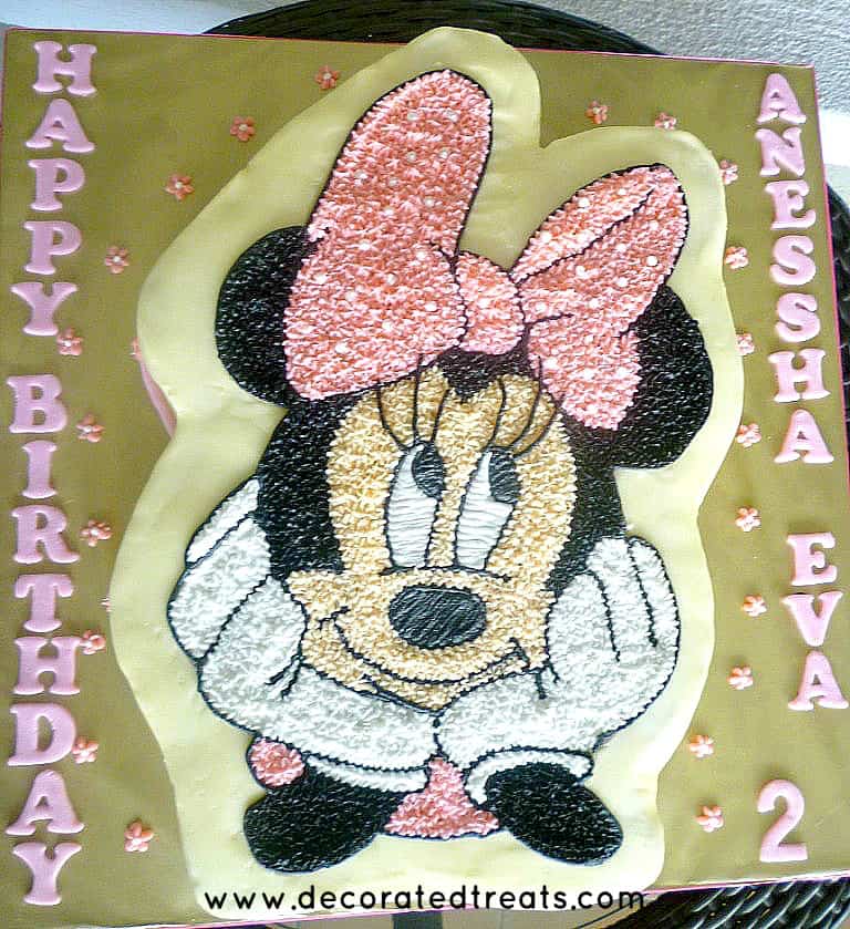 Minnie Mouse cake on a gold cake board.