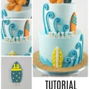 A 2 tier blue beach themed birthday cake with colorful fondant surfboards, and an orange hibiscus topper