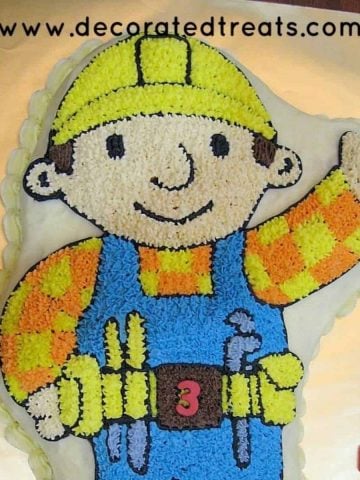 Bob the Builder cake on a gold cake board.
