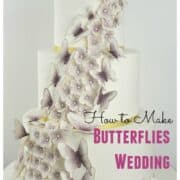 A 3 tier white wedding cake decorated with cascading gum paste hydrangea and butterflies in purple