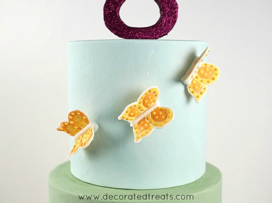 The sides of a cake with 3D butterflies